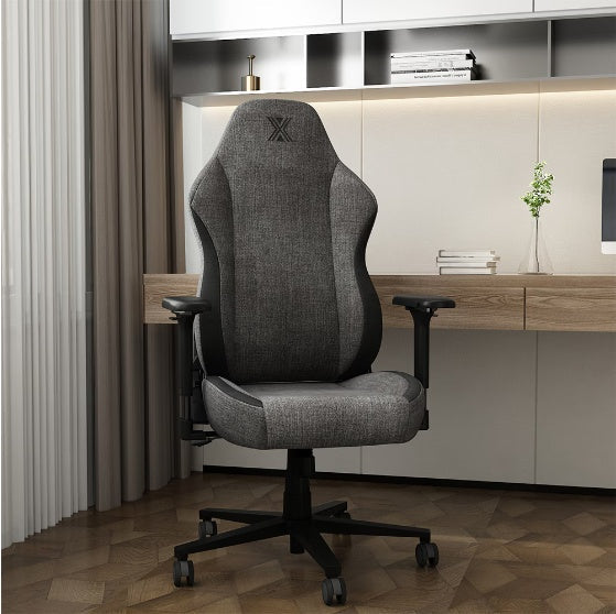 Ergonomic desk chair with lumbar support, flip armrests, and headrest in black and gray fabric.