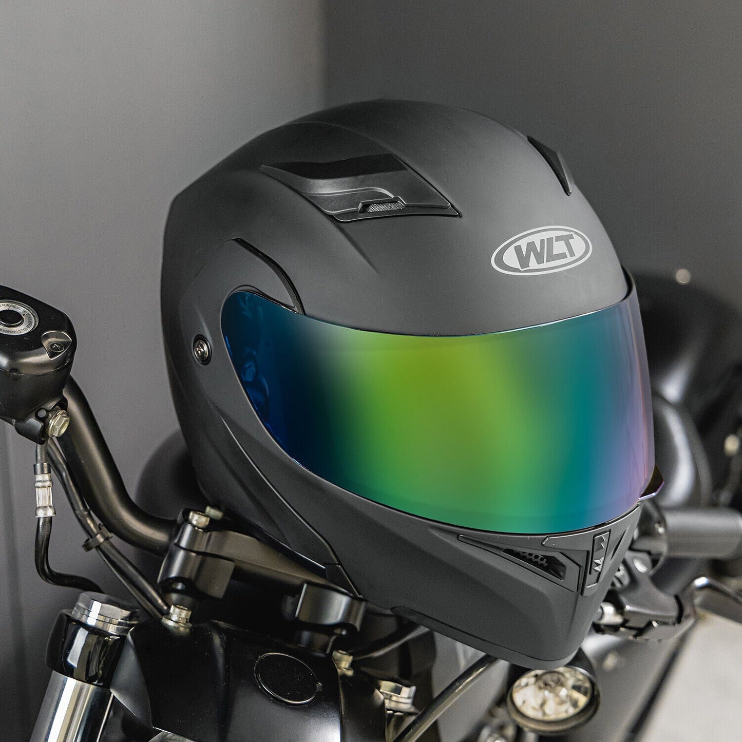 Full face dual visor flip modular motorcycle helmet with color lens on a bike.