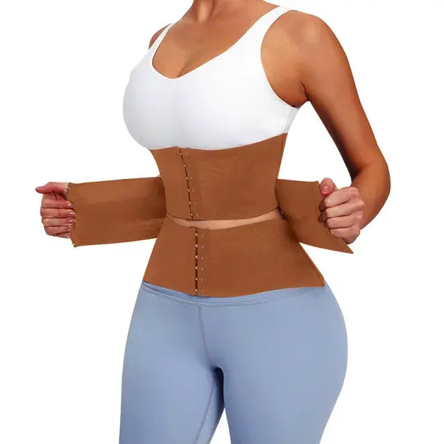 Woman wearing brown body shapewear tummy wrap waist trainer corset with white sports bra and blue leggings