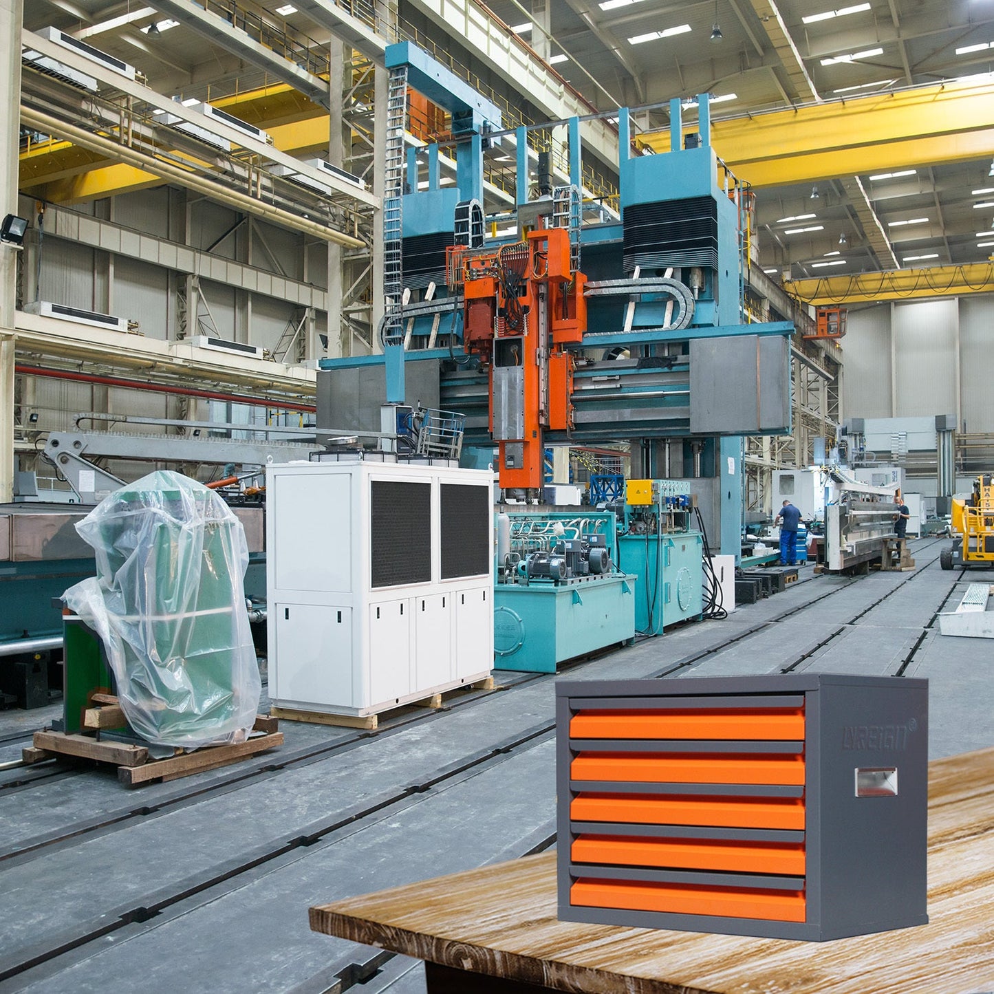 Industrial storage cabinet with multiple orange drawers, designed for organizing metal-coated pieces, in a large manufacturing facility.