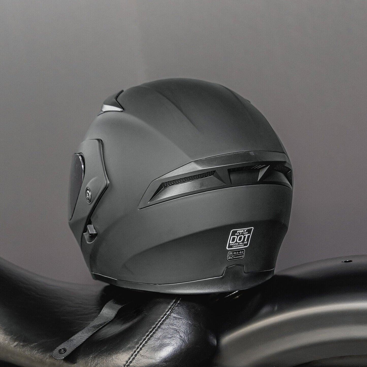 Full Face Dual Visor Flip Moto Helmet with Color Lens on motorcycle seat.