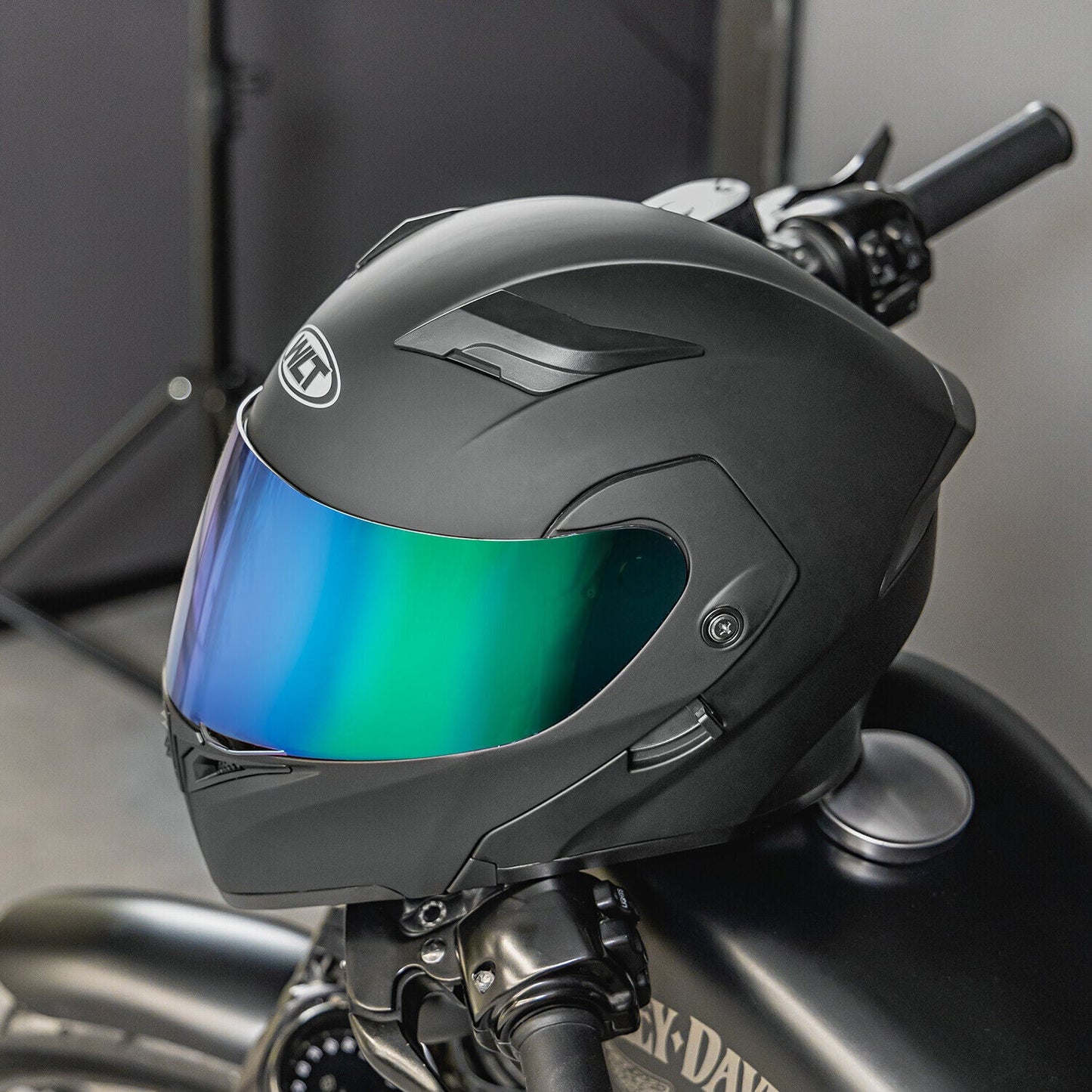 Full face dual visor modular motorcycle helmet with color lens on a bike.