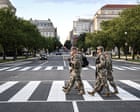 National guard troops deployed in DC rake leaves and clear homeless camps