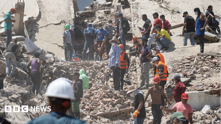 People searching for survivors in rubble