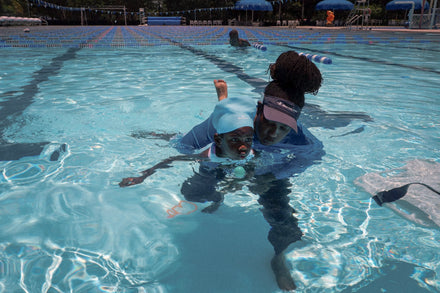 A child with autism in a swimming pool with an instructor